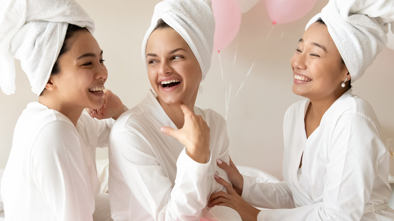 three women laughing together