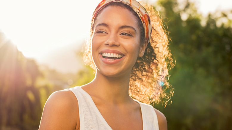 Black woman smiling in daylight