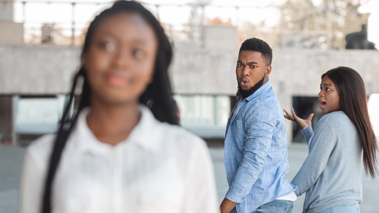 man checking out another woman