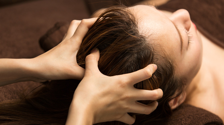 woman getting her scalp massaged