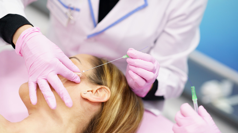 Patient receiving mono-thread lift in cheek