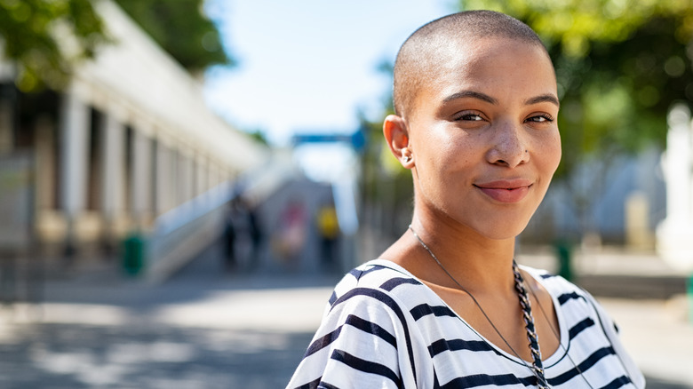 woman with freckles standing outside