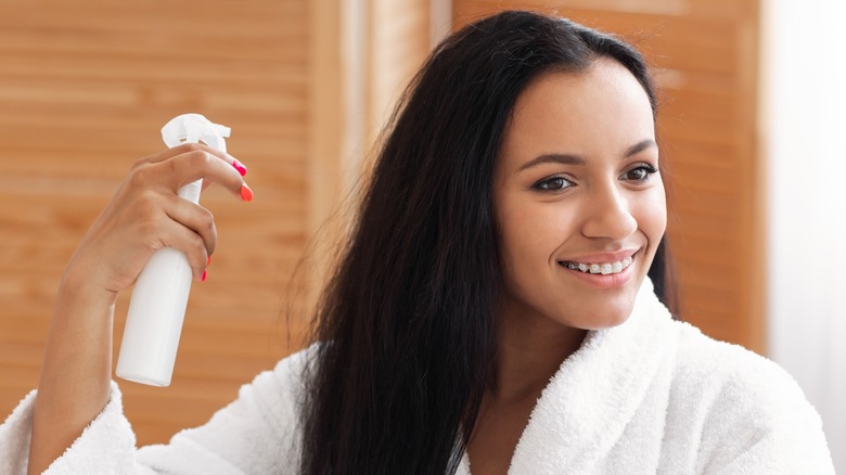 Woman spraying her long hair