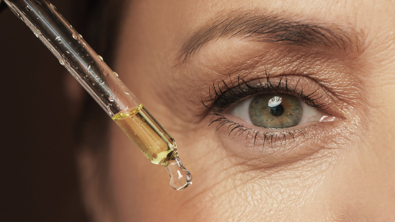 woman applying serum on wrinkles