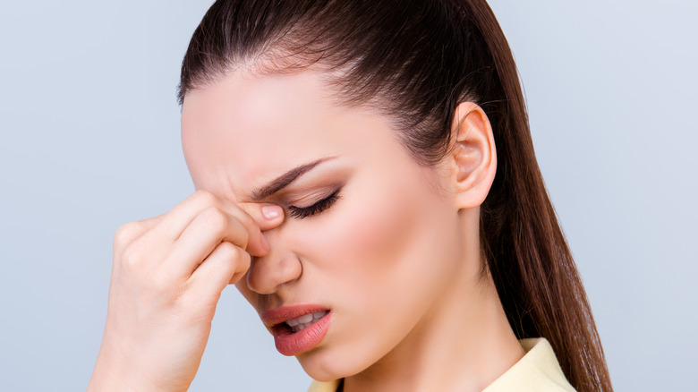 Woman pressing bridge of nose