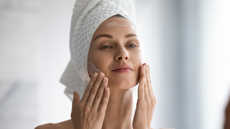 Woman applying skincare 