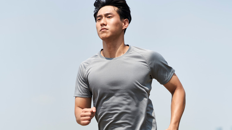 Asian man jogging outside