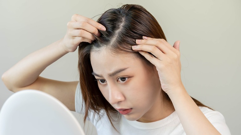 Model looking at longer thinning hair