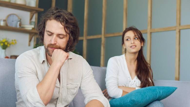 unhappy couple on couch