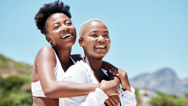 lesbian couple hugging and enjoying nature 