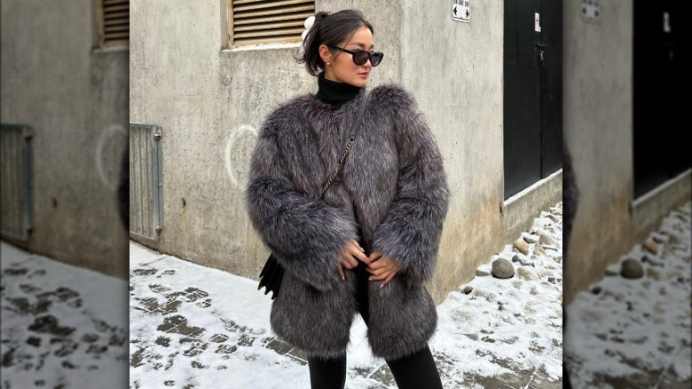 Model wearing faux fur statement coat