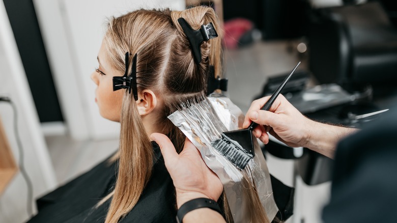 Woman getting hair highlights