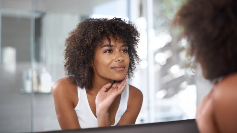 Woman looking in mirror