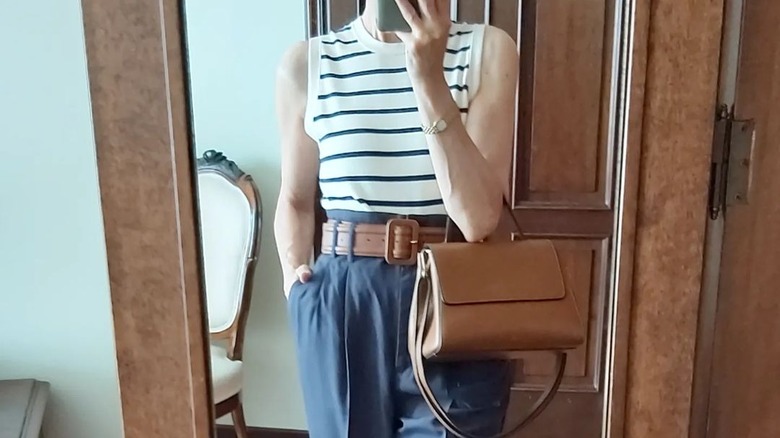 Woman top tucked into high-waisted pants