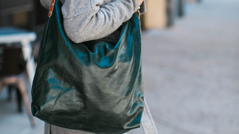 woman with green hobo bag