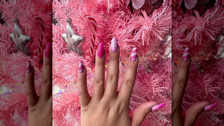 pink festive nails near tree