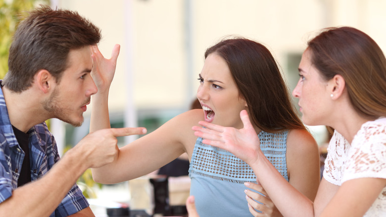 three people arguing