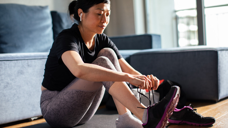 woman tying shoes