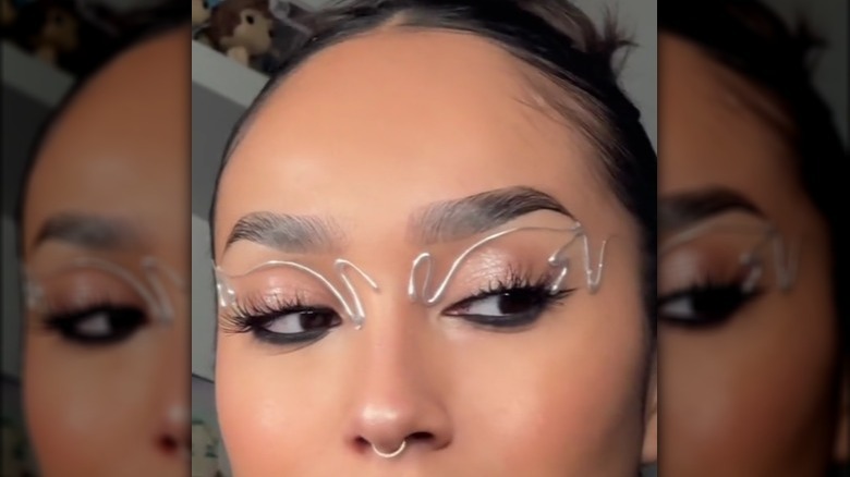 woman with hot glue eyeliner