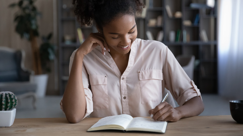 woman writing in notebook