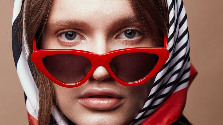 Model wearing red cat eye glasses