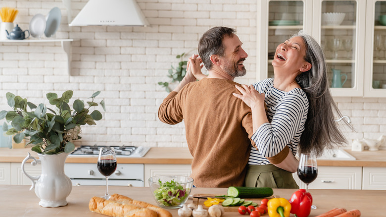 elderly couple dancing in kitchen