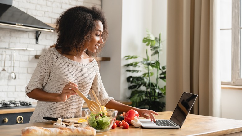 african american woman food laptop