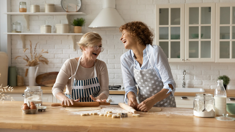 women laughing kitchen dough 