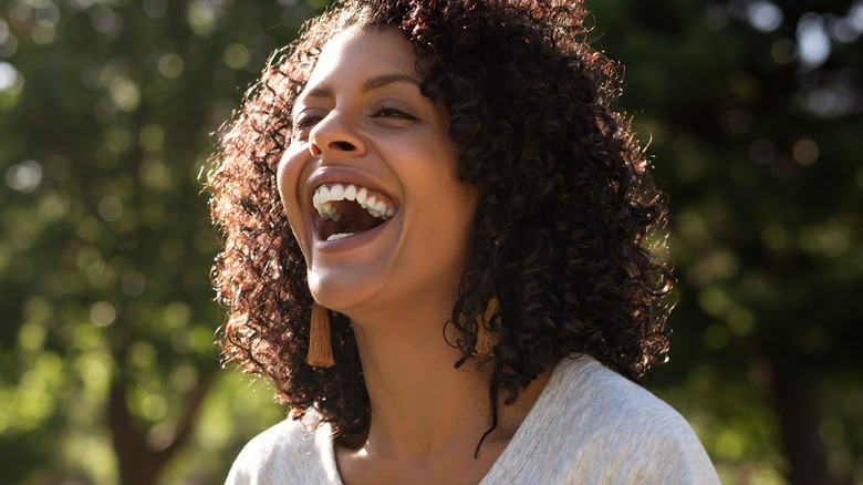 Woman smiling and laughing in the sun