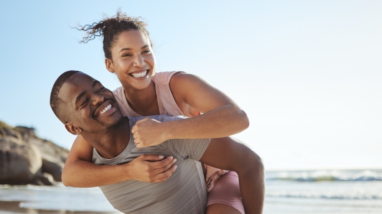 Man giving woman piggyback ride