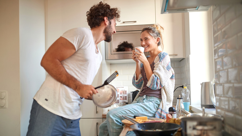 young couple hanging out in kitchen