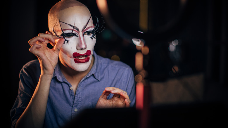 Drag queen attaches dramatic lashes