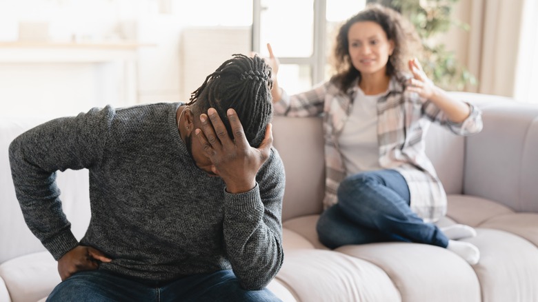 Two people arguing on couch