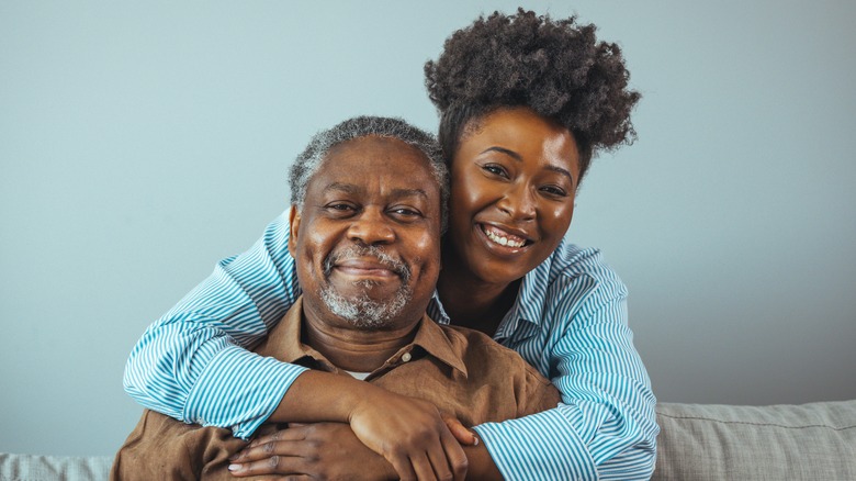 Two people hugging and smiling