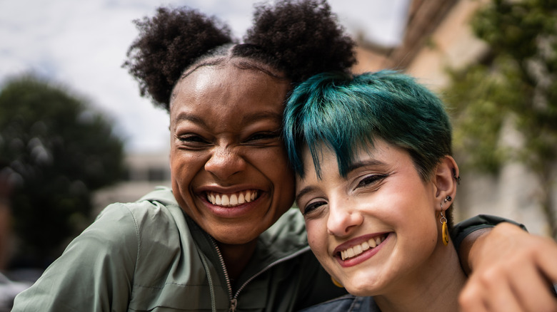 Two women embrace and smile