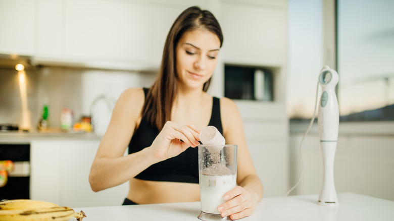 woman making protein drink