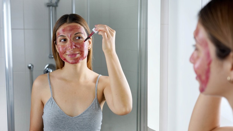 Woman applying an exfoliating mask