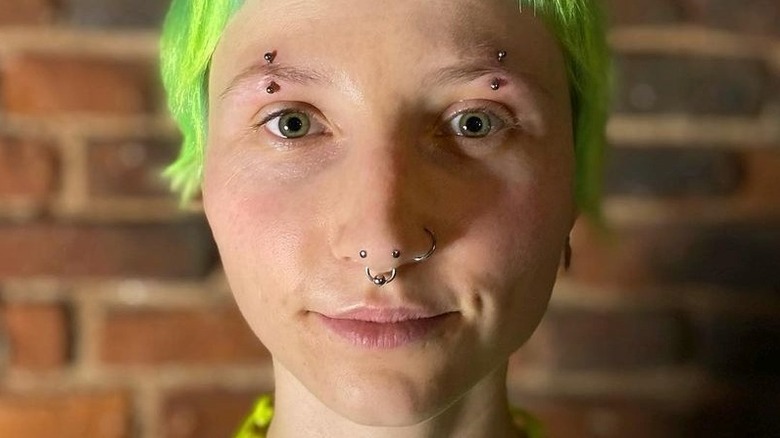 Close up of austin bar piercing, septum piercing, and nostril piercing