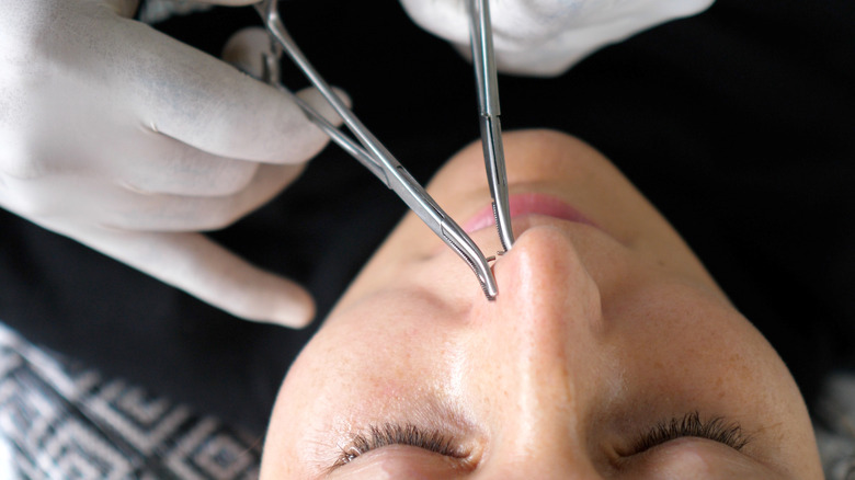 Person getting their nose pierced