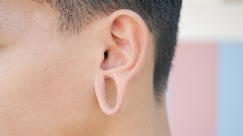 ear with guage and hole