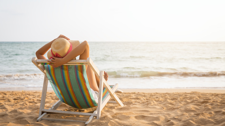 person laying on beach