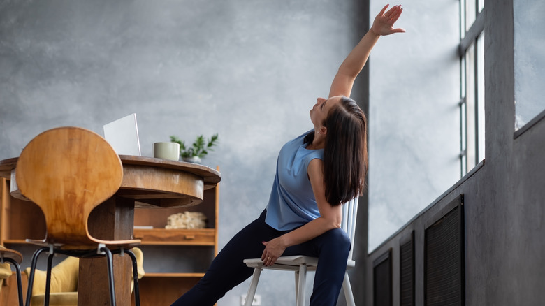 woman stretching on chair