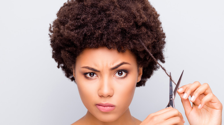 woman with scissors and curly hair