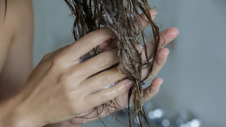 woman applying leave-in hair treatment