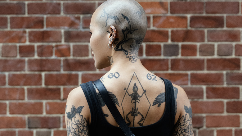 Woman with edgy back tattoos