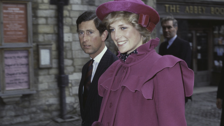 Princess Diana smiling in frilly coat