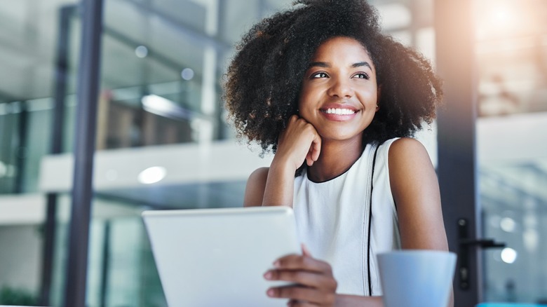 Woman at work smiling with laptop