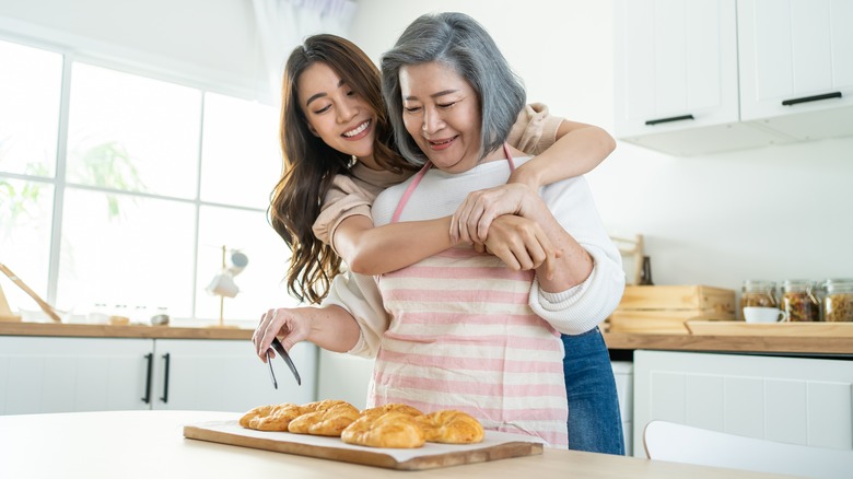 Two women smiling with baked goods