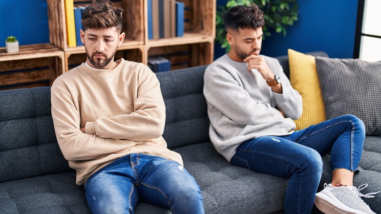 couple sitting on couch sadly