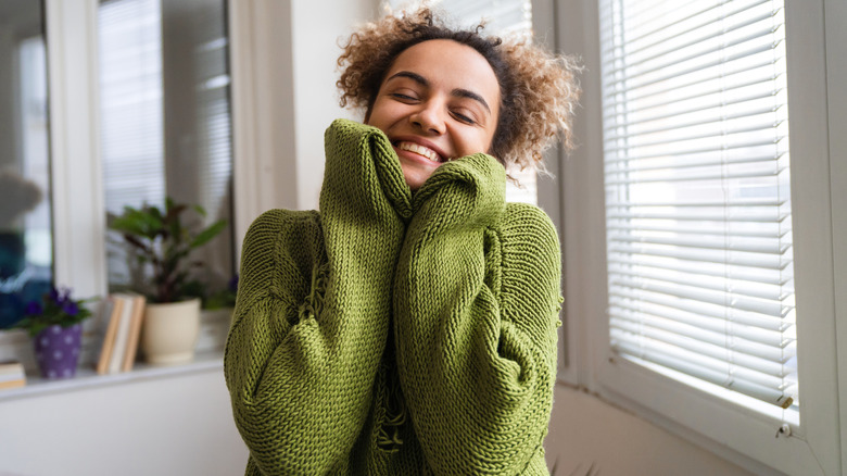 happy woman in green sweater